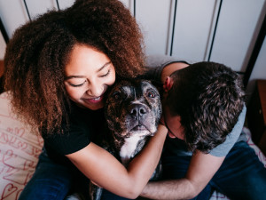 Couple hugging their Pit Bull