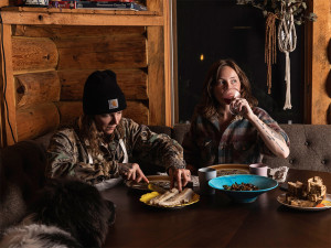 two people preparing food for their dogs