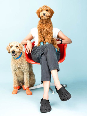 woman and dog both wearing crocs