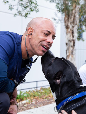 Dr. Kwane Stewart and a large black dog.