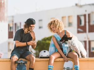 two people bonding and smiling over a dog