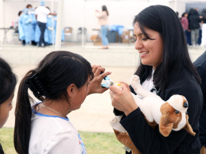 a child helps clip a fake dog's nails 