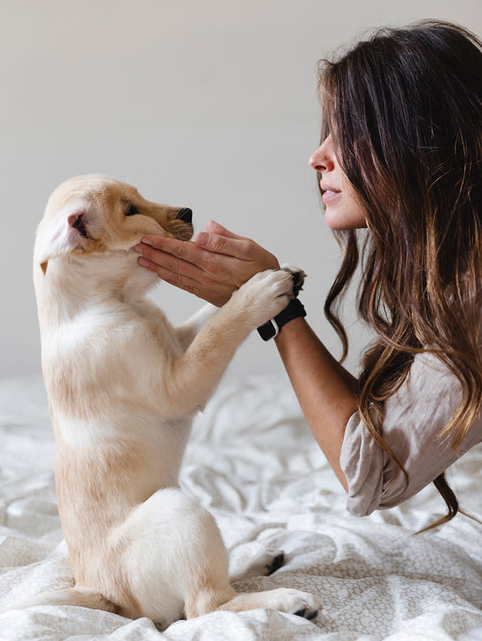 Woman playing with her puppy.