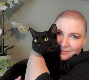 LeeAnna Buis hugs a black cat