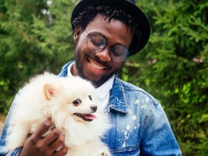 Man hugging his fluffy white dog happily