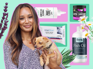 Dr. Lindsey Wendt holds a dog in front of a collection of allergy products.